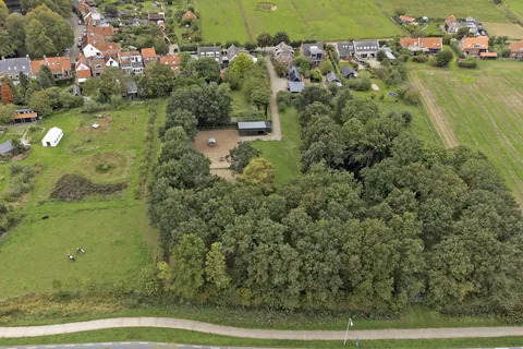 Luchtfoto van het perceel met het dorp Nisse op de achtergrond